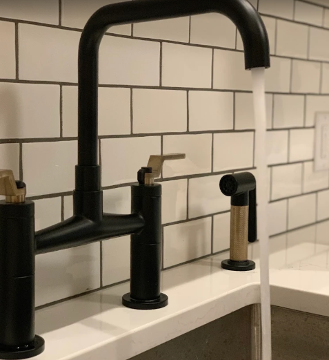 Matte black kitchen faucet above an undermount sink